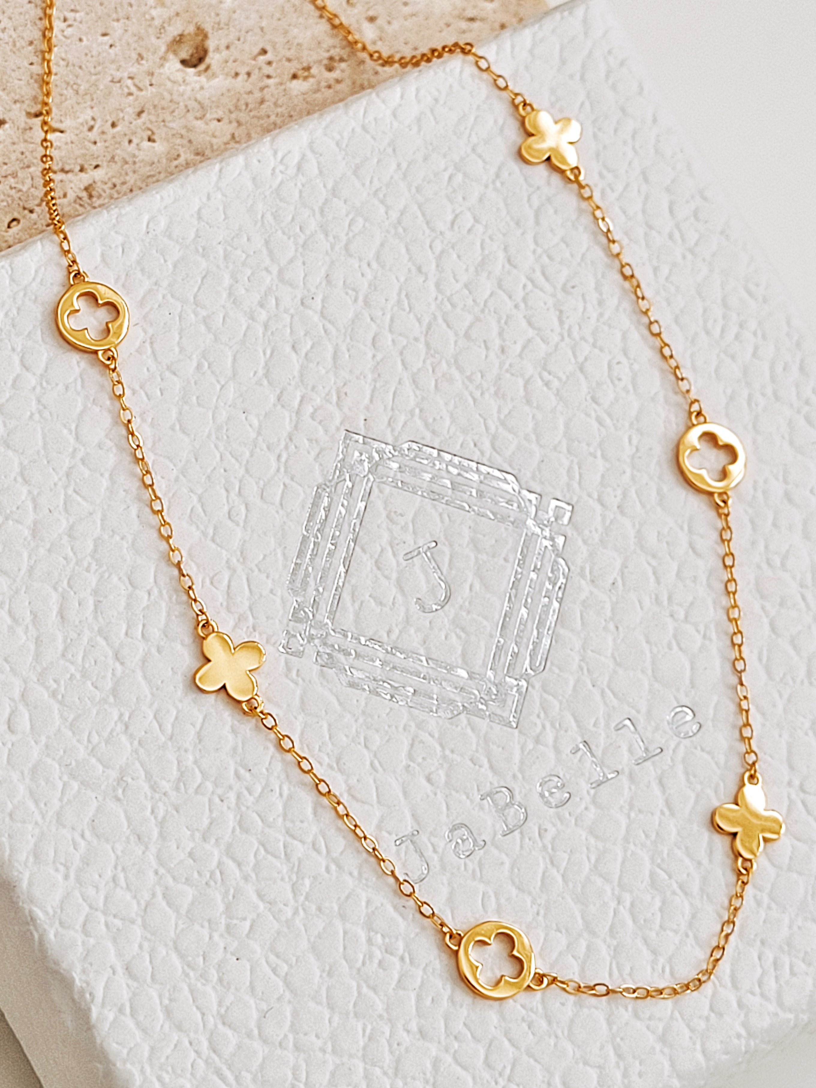 Dainty gold plated clover necklace displayed on JaBelle Jewellery box.