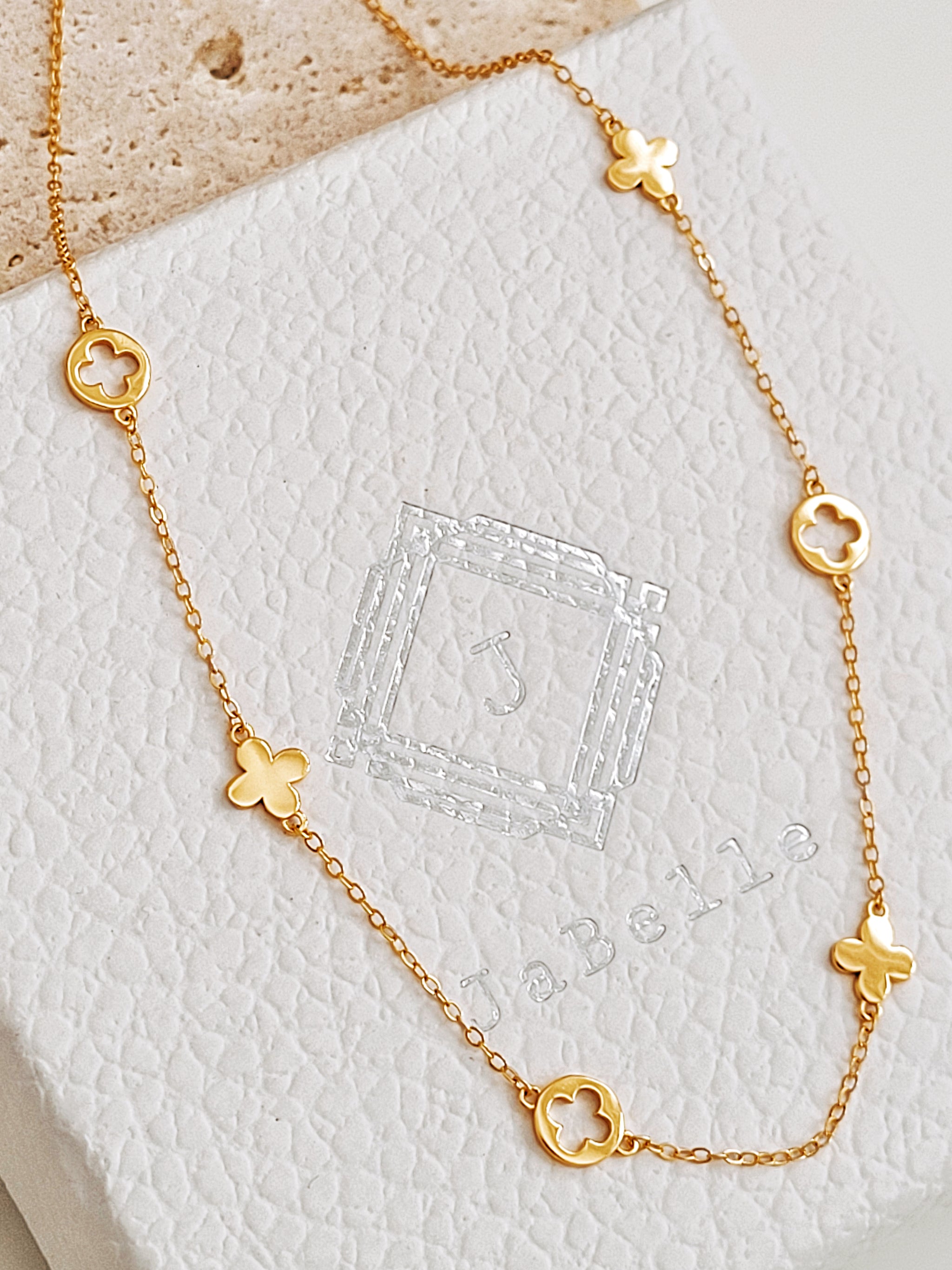 Dainty gold plated clover necklace displayed on JaBelle Jewellery box.