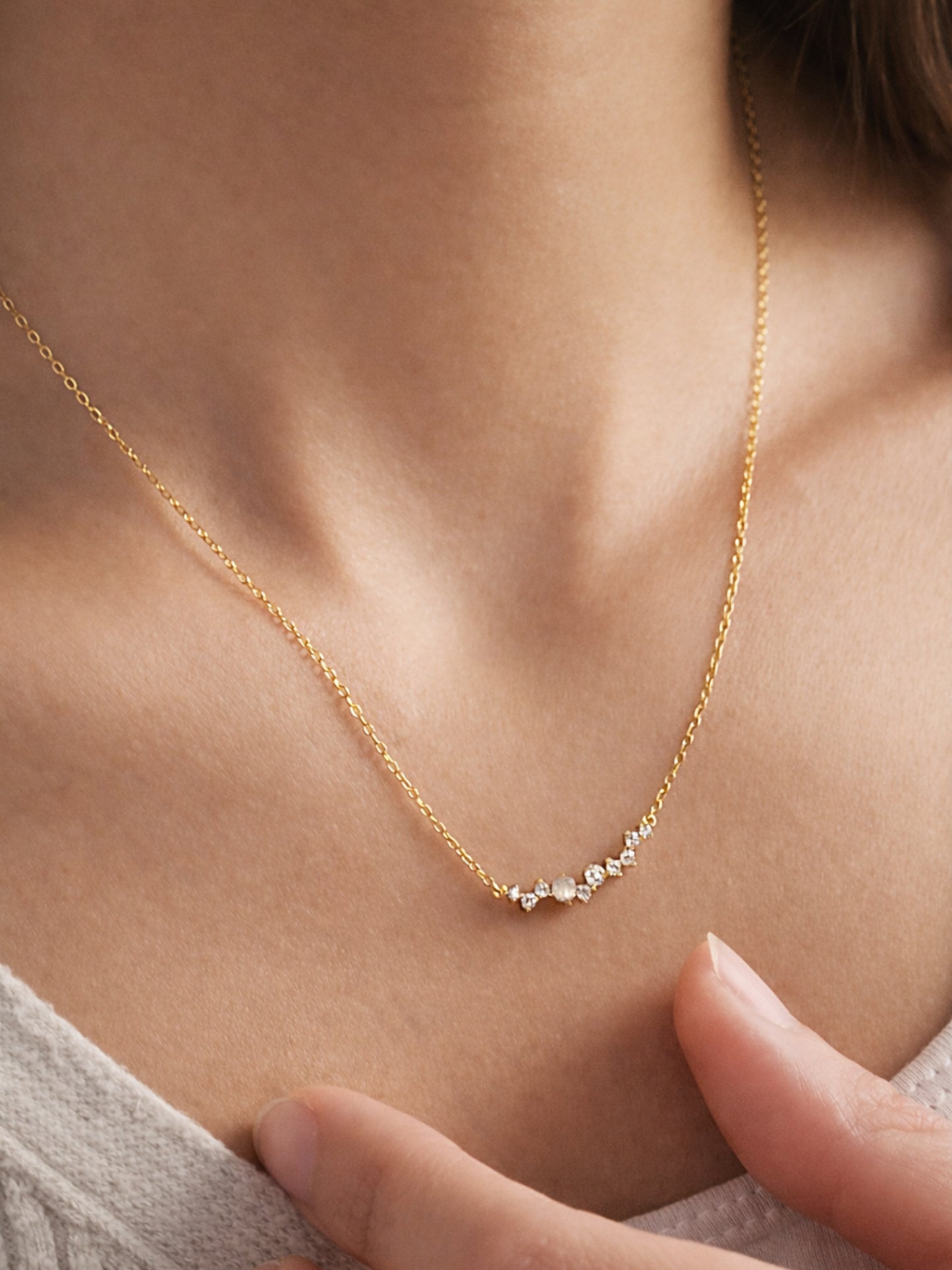 Dainty gold plated sterling silver diamond necklace worn on a woman