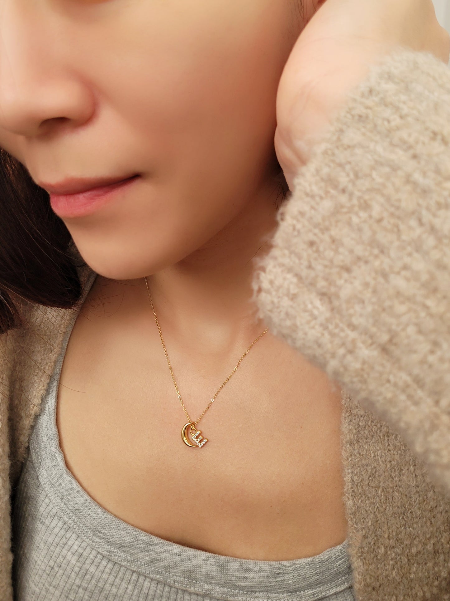 Model wearing custom gold plated crescent letter charm necklace. Crafted in 18k gold vermeil, best birthday gift for her.