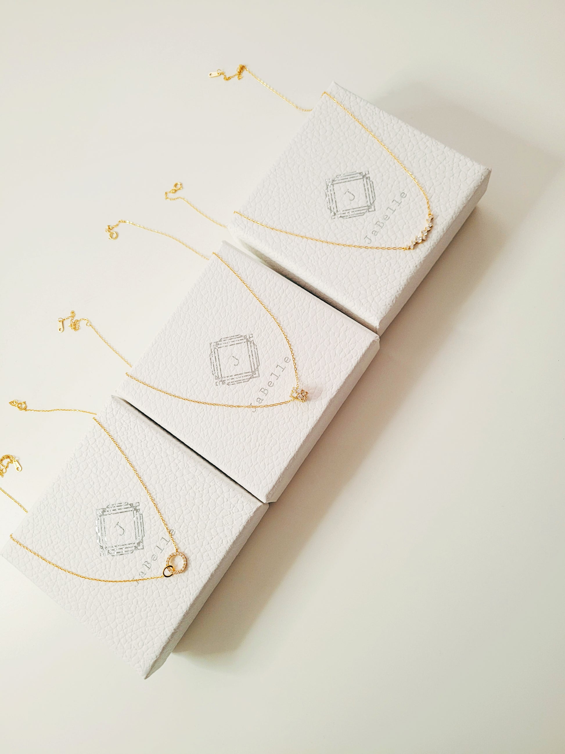 Dainty gold cluster necklaces with zirconia accents, a versatile and stylish gift for her.