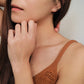 Close-up of a woman&#39;s ear wearing an 18K gold-plated cubic zirconia climber earring, highlighting the elegant and minimalist design.