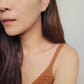 Close-up of a woman&#39;s ear wearing an 18K gold-plated cubic zirconia climber earring, highlighting the elegant and minimalist design.