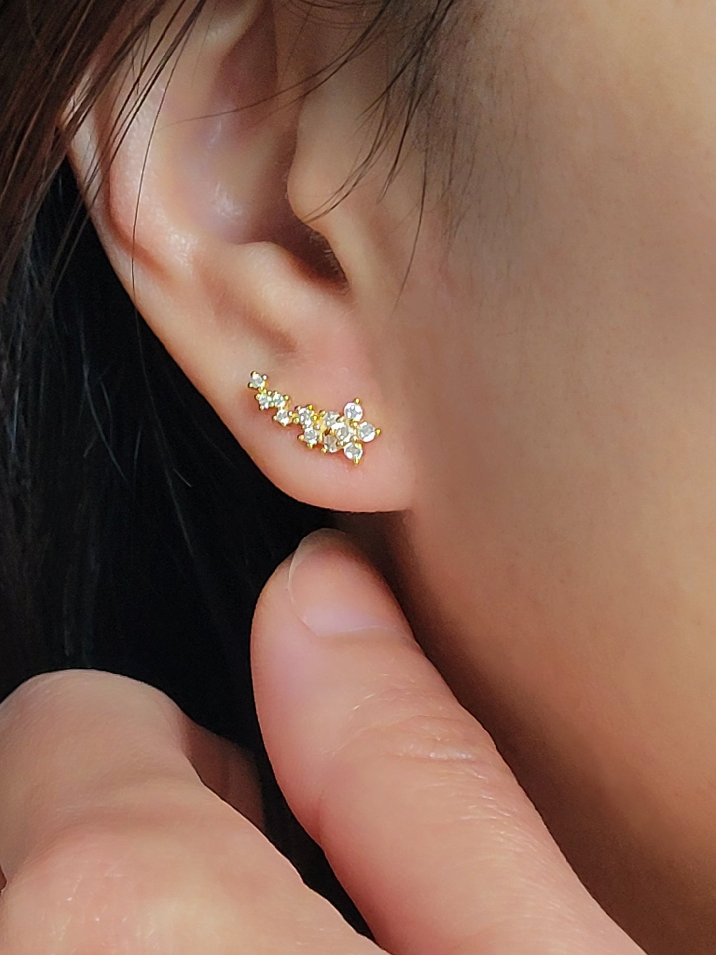 Gold floral ear climbers designed with sparkling cubic zirconia, perfect for weddings or special occasions.