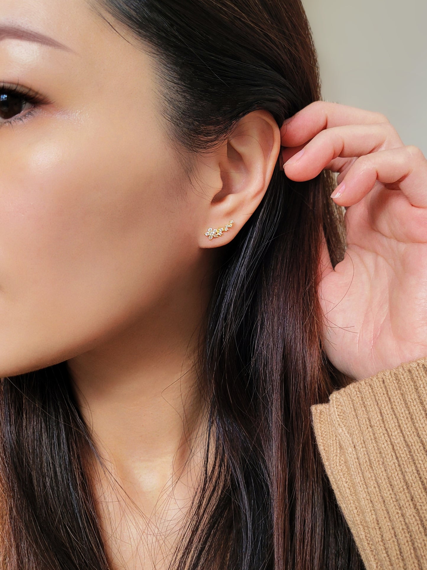 Gold floral ear climbers designed with sparkling cubic zirconia, perfect for weddings or special occasions.