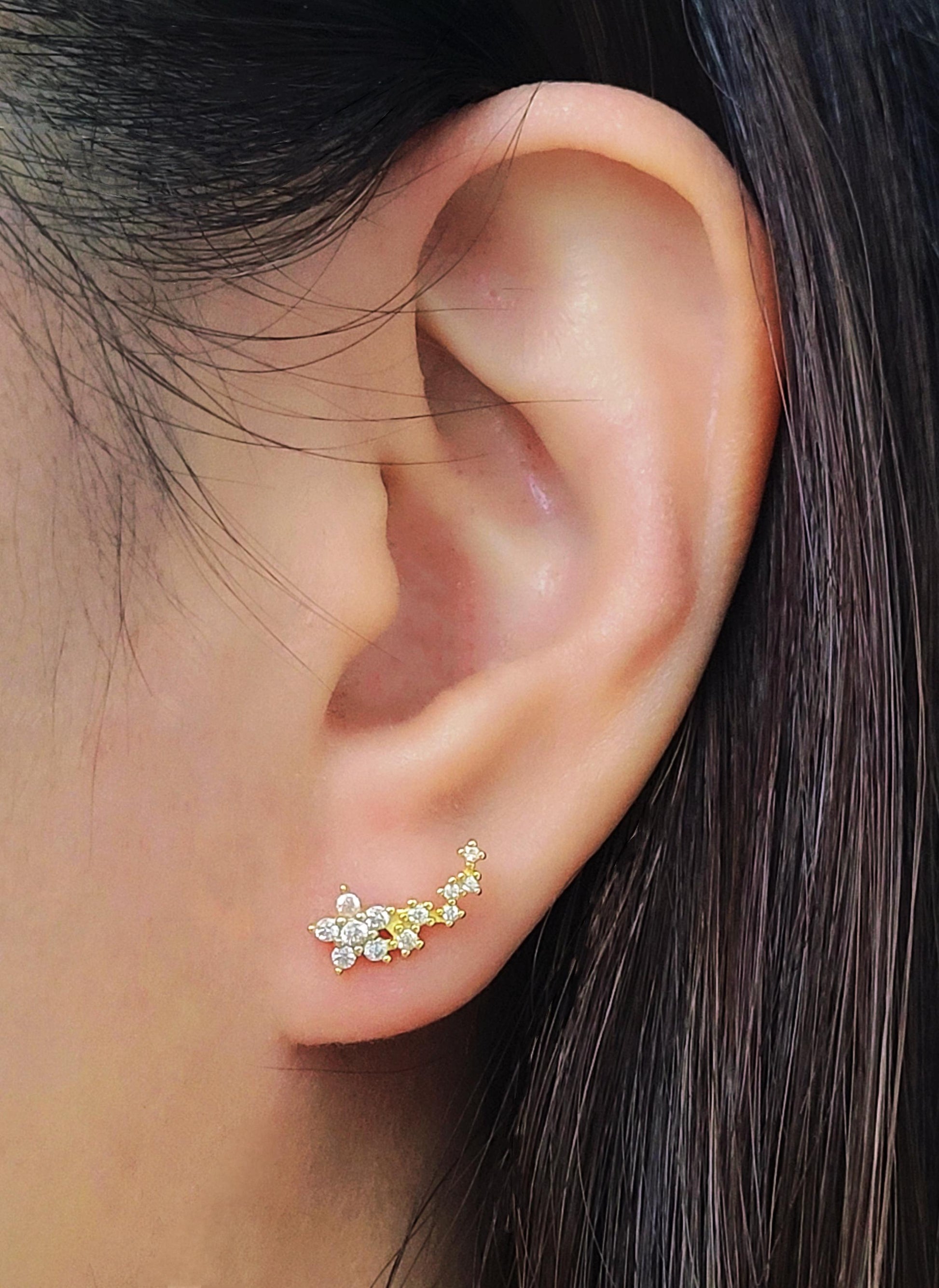 Gold floral ear climbers designed with sparkling cubic zirconia, perfect for weddings or special occasions.