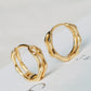 Close-up image of double hoop huggie earrings in octagon shape, featuring a minimalist gold geometric design, worn on an ear. Perfect for everyday wear.