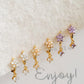 Set of gold flower earrings with clear zirconia, purple zirconia and yellow zirconia stone.