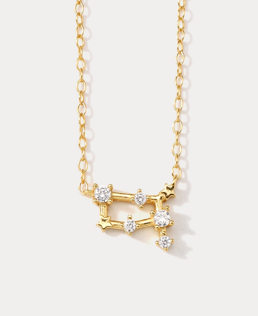 A dainty gold necklace with a pendant featuring a stylized Gemini zodiac constellation sign with sparkling zircons crafted in gold plated sterling silver. Ideal birthday gift for her.