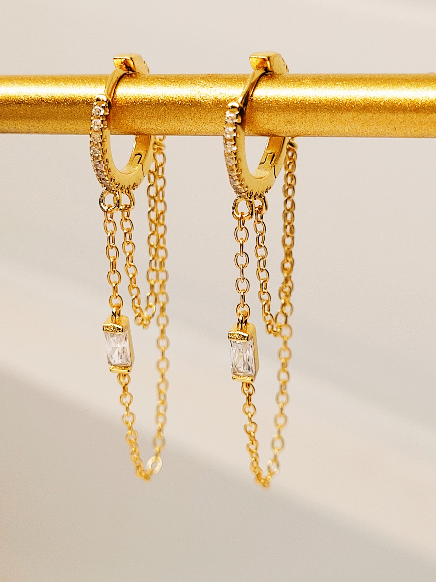 A pair of 14k gold chain huggie hoop earrings with double chain detail and diamond accent, perfect minimalist gold jewellery gift for her.