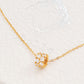 Luxurious close-up of a gold round shaped barrel necklace featuring sparkling pave zircons.