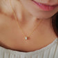 Luxurious close-up of a gold round shaped barrel necklace featuring sparkling pave zircons.