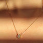 Luxurious close-up of a gold round shaped barrel necklace featuring sparkling pave zircons.