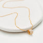 Luxurious close-up of a gold round shaped barrel necklace featuring sparkling pave zircons.