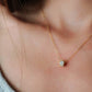 Luxurious close-up of a gold round shaped barrel necklace featuring sparkling pave zircons.