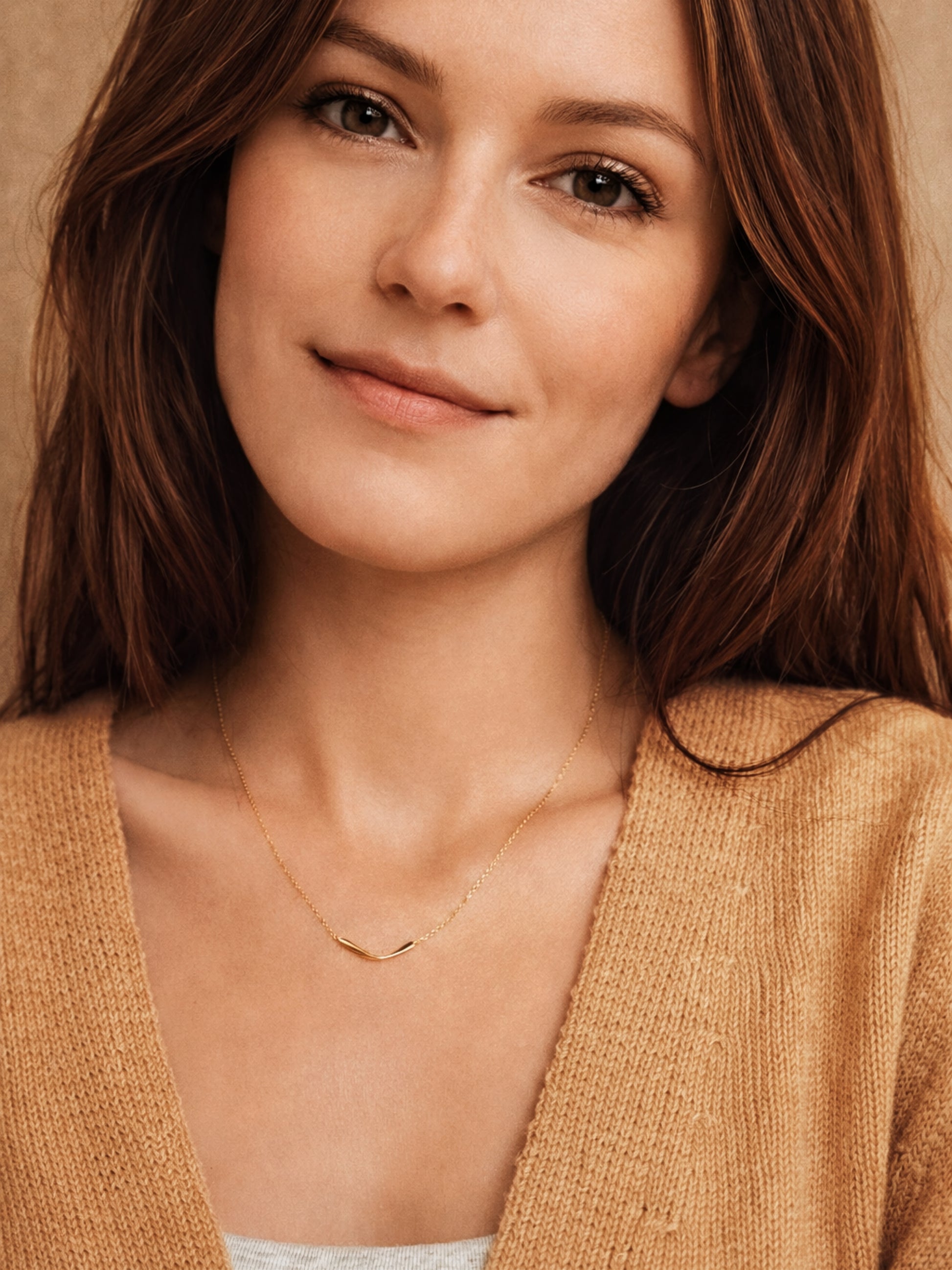 Woman wearing a dainty gold necklace featuring a curve bar pendant against a neutral background
