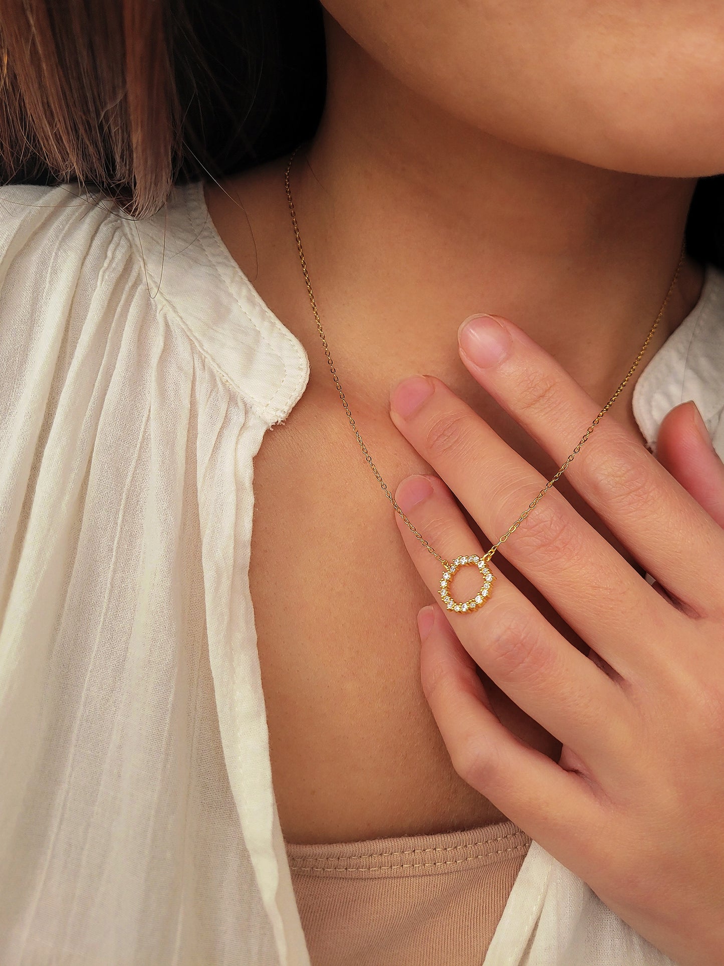 Model wearing Gold Vermeil Infinity Circle Necklace, showcasing its minimalist design.