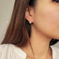Elegant dangle earrings featuring a sparkling cubic zirconia stone set in 18k gold vermeil, perfect for everyday wear.