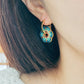 Close up of Green Enamel Flower Portugal Tile earrings.