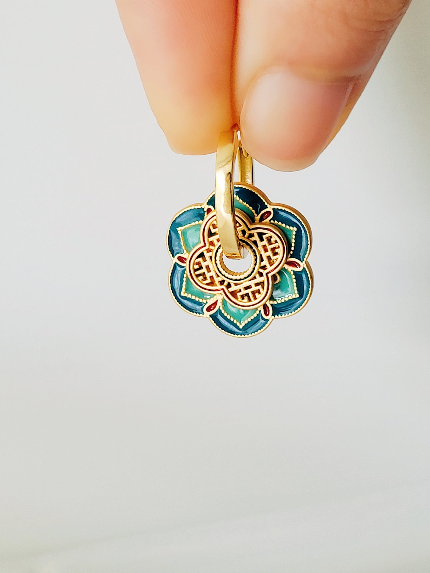 Close up of Green Enamel Flower Portugal Tile earrings.