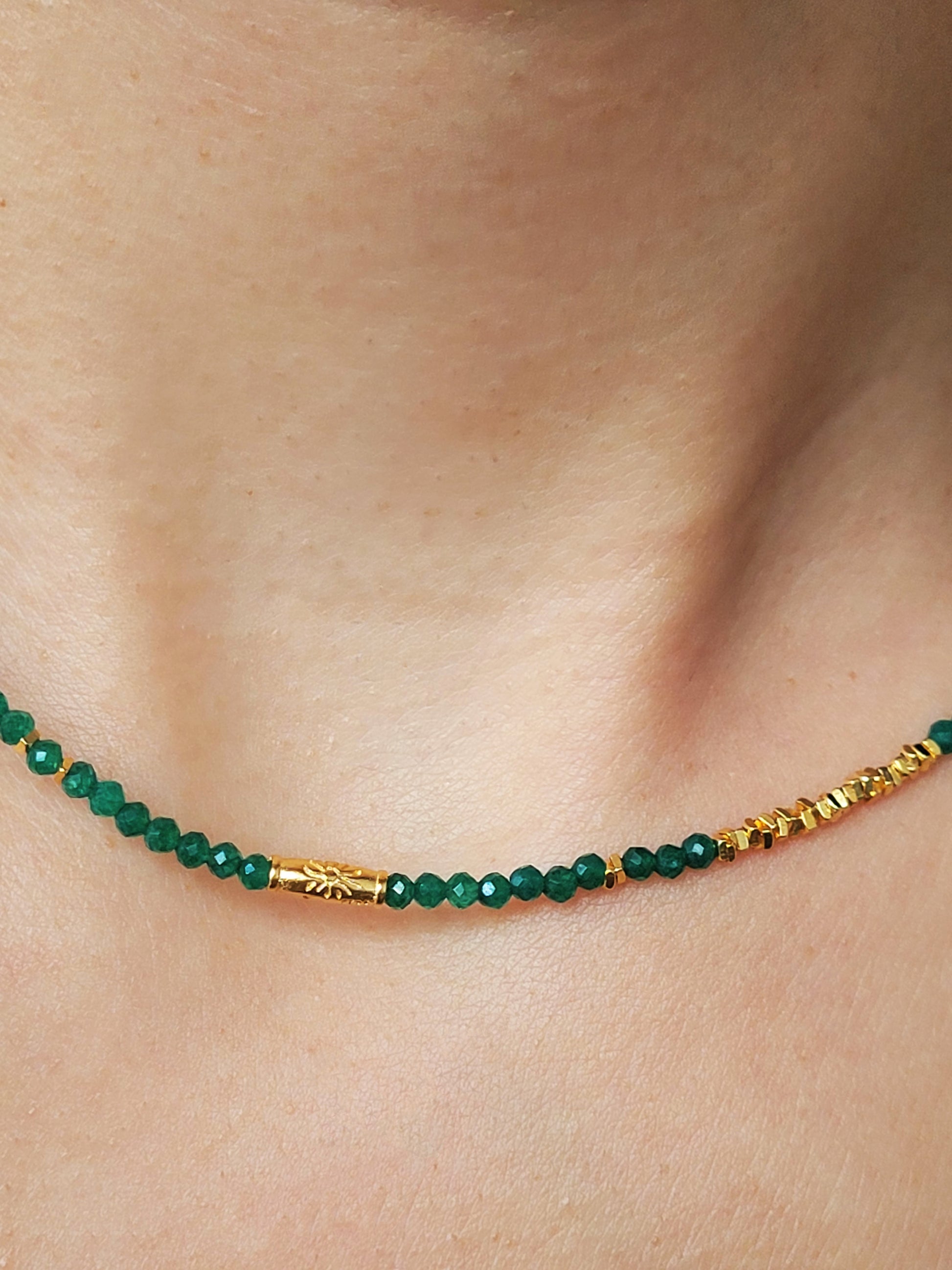 A close-up of a woman&#39;s neck wearing a Green Onyx Beaded Necklace with 18k Gold Vermeil beads, showcasing an elegant minimalist design perfect for everyday wear or special occasions.