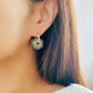 Close up of Green Enamel Flower Portugal Tile earrings.