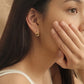 Woman wearing the Halo Drop Stud Earrings crafted in 18k gold vermeil with cubic zirconia accents, simple everyday earrings