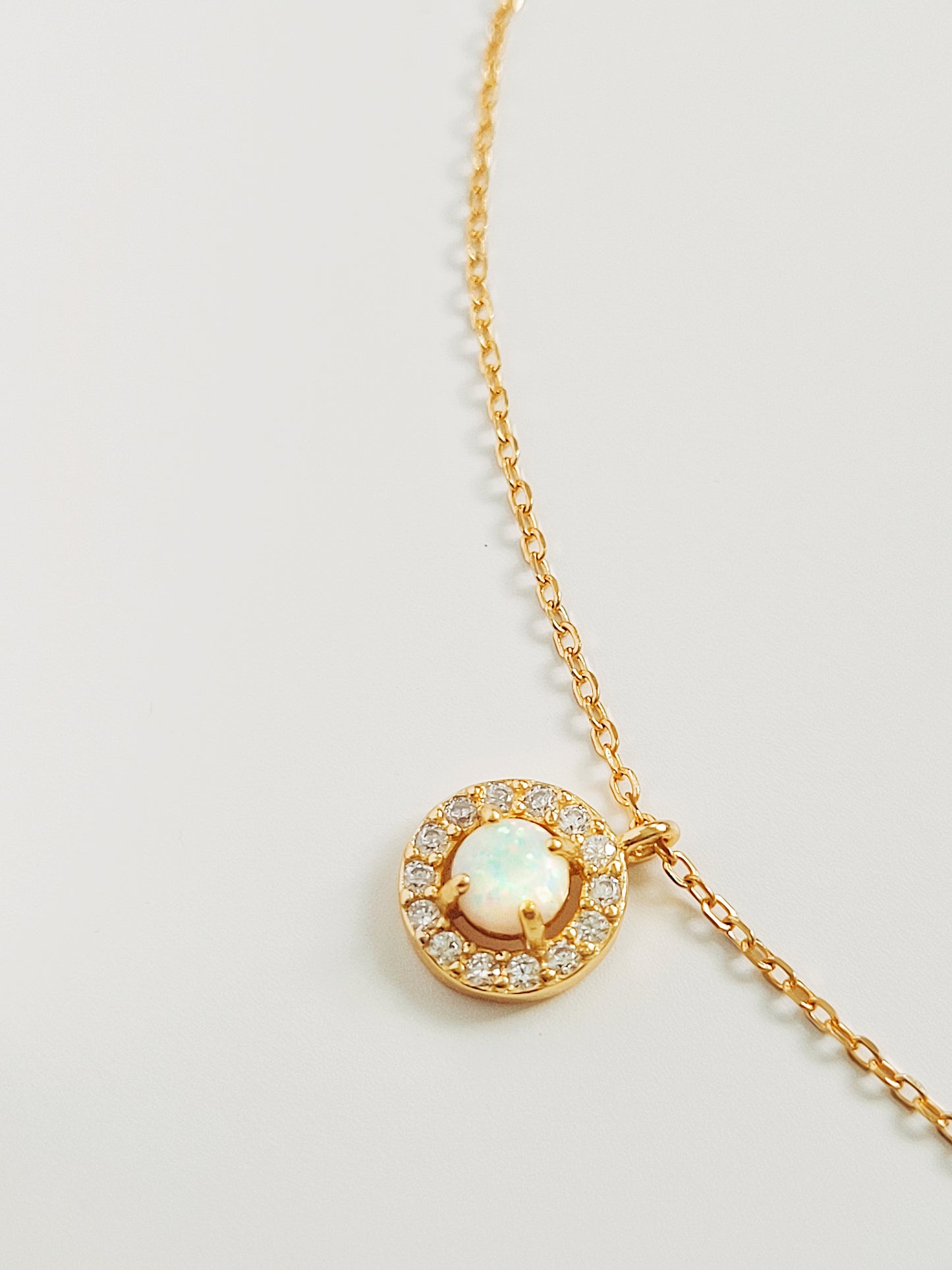 Halo Fire Opal Necklace crafted in yellow gold vermeil.