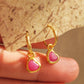 Close up of a pair of pink heart earrings, showcasing its details and beauty of natural gemstone