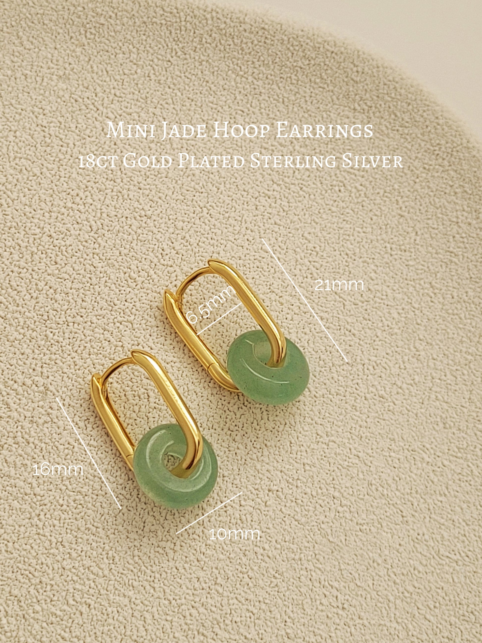 Close-up of a pair of green jade link hoop earrings, showcasing their elegant and minimalist design.