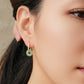 Close up of a woman wearing dainty jade hoop earrings, minimalist and delicate genuine jade jewellery.