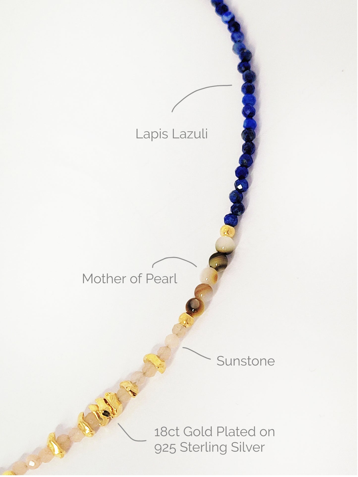 Close up of a blue lapis lazuli beaded necklace featuring a mix of gemstones and elegant gold vermeil beads. Handcrafted for a unique, luxurious look. Perfect for any occasion. Stand out in style with this exquisite piece!