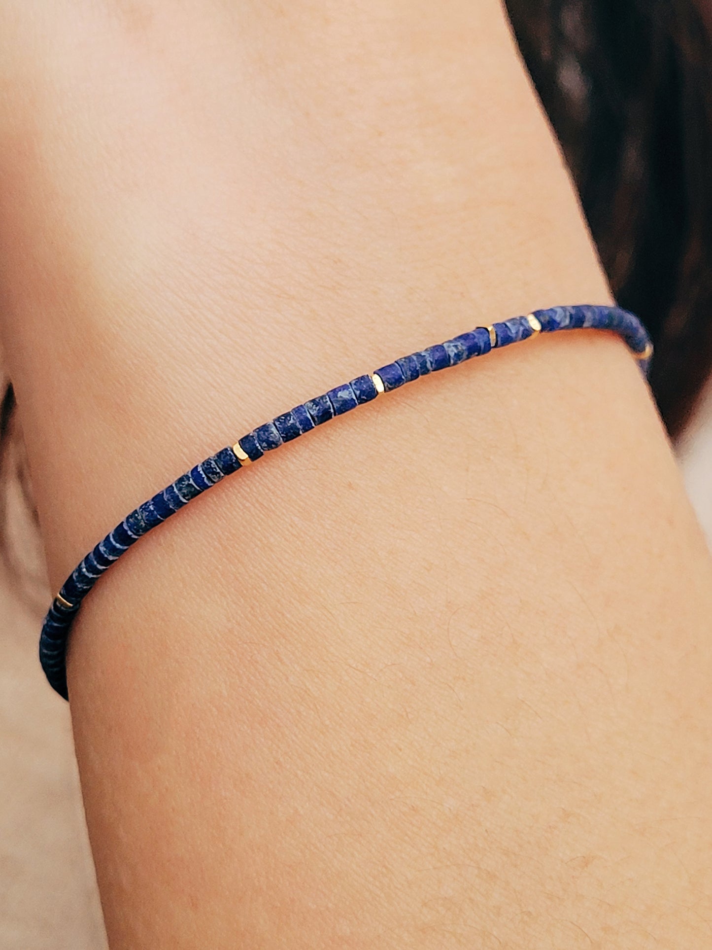 A minimalist gemstone bracelet featuring high-quality 2mm royal blue Lapis Lazuli beads paired with 18k gold vermeil accents, creating a delicate and timeless design perfect for stacking or wearing alone.