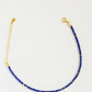 A minimalist gemstone bracelet featuring high-quality 2mm royal blue Lapis Lazuli beads paired with 18k gold vermeil accents, creating a delicate and timeless design perfect for stacking or wearing alone.