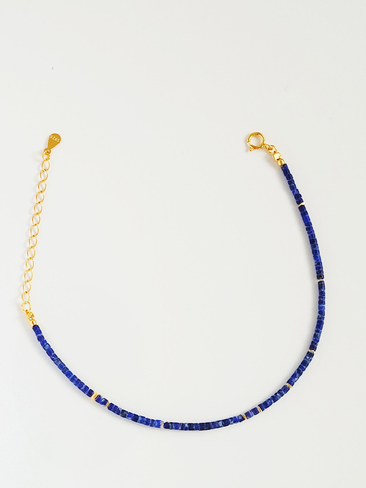 A minimalist gemstone bracelet featuring high-quality 2mm royal blue Lapis Lazuli beads paired with 18k gold vermeil accents, creating a delicate and timeless design perfect for stacking or wearing alone.