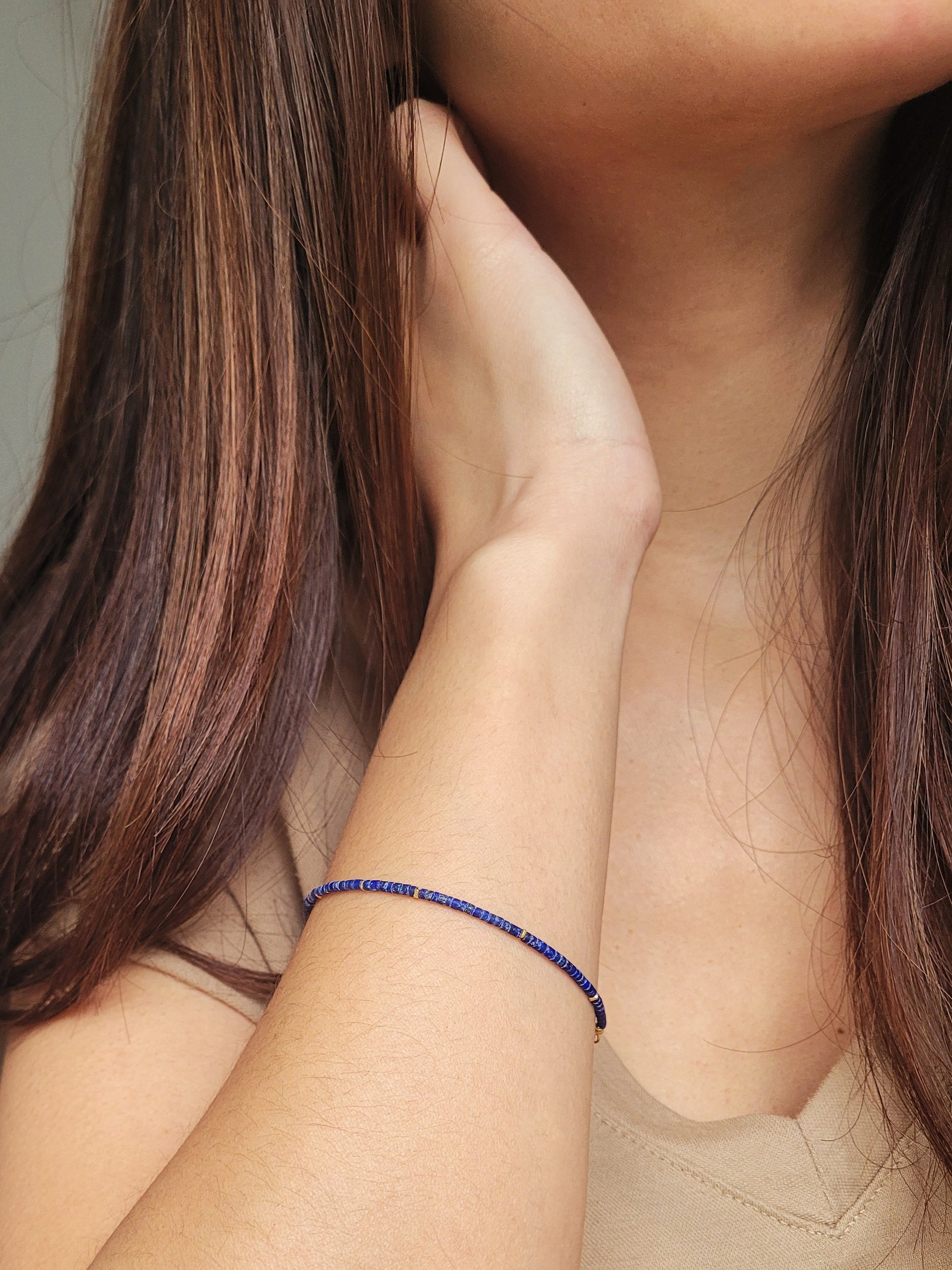 A minimalist gemstone bracelet featuring high-quality 2mm royal blue Lapis Lazuli beads paired with 18k gold vermeil accents, creating a delicate and timeless design perfect for stacking or wearing alone.