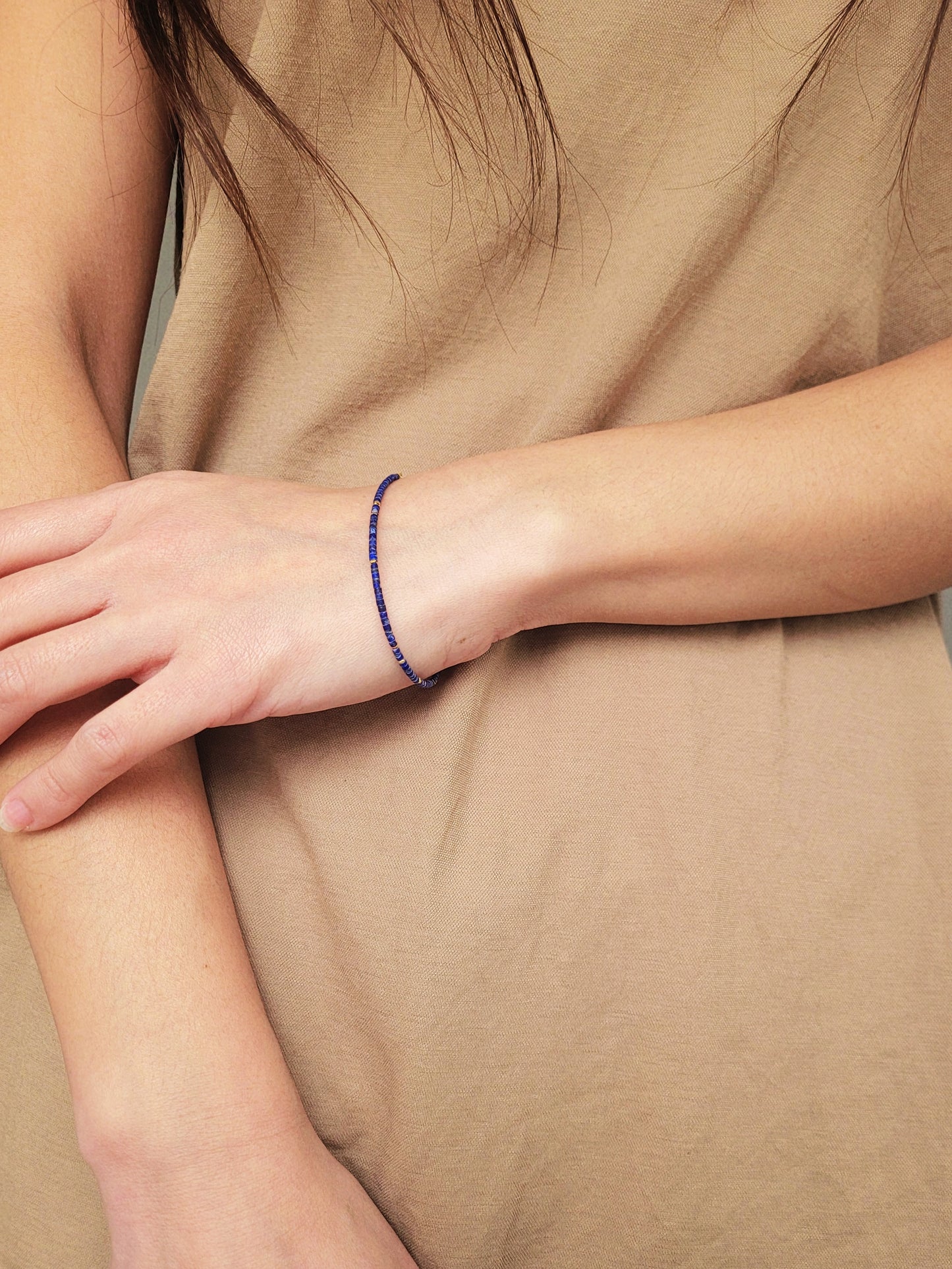 A minimalist gemstone bracelet featuring high-quality 2mm royal blue Lapis Lazuli beads paired with 18k gold vermeil accents, creating a delicate and timeless design perfect for stacking or wearing alone.