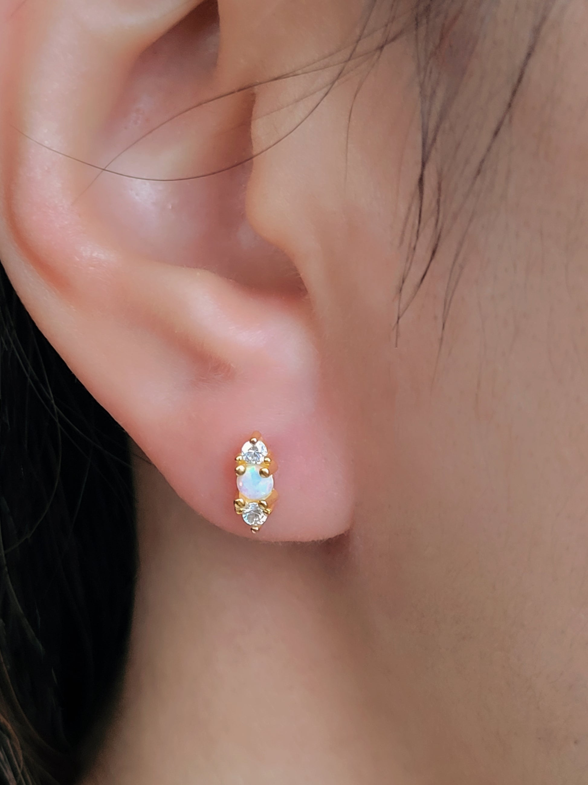 Side view of mini opal earrings, highlighting the intricate craftsmanship and gold vermeil finish. Perfect to stack with other studs.