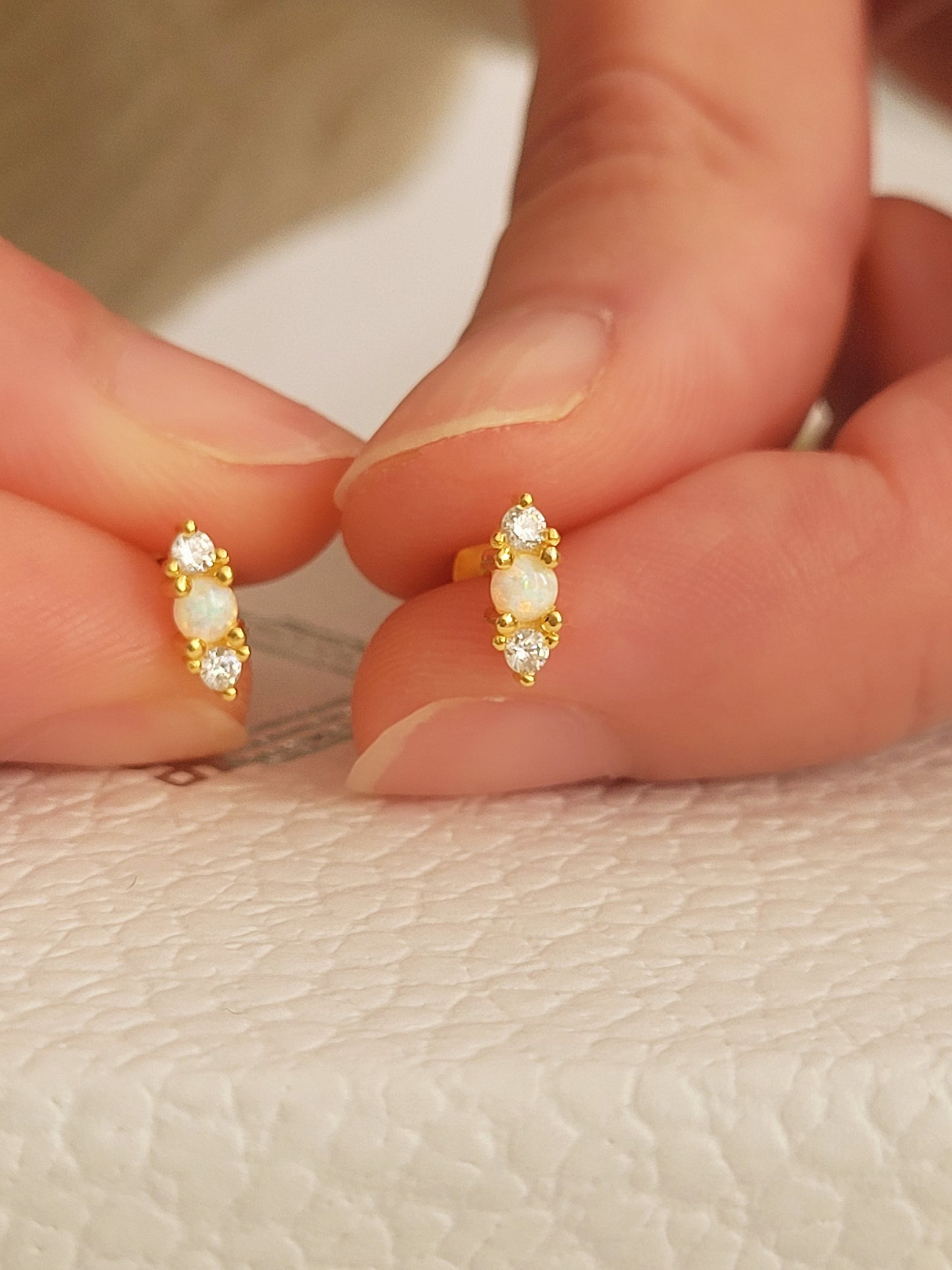 Natural opal earrings with sparkling zirconia and gold accents. Simple and elegant opal stud earrings with a touch of sparkle.