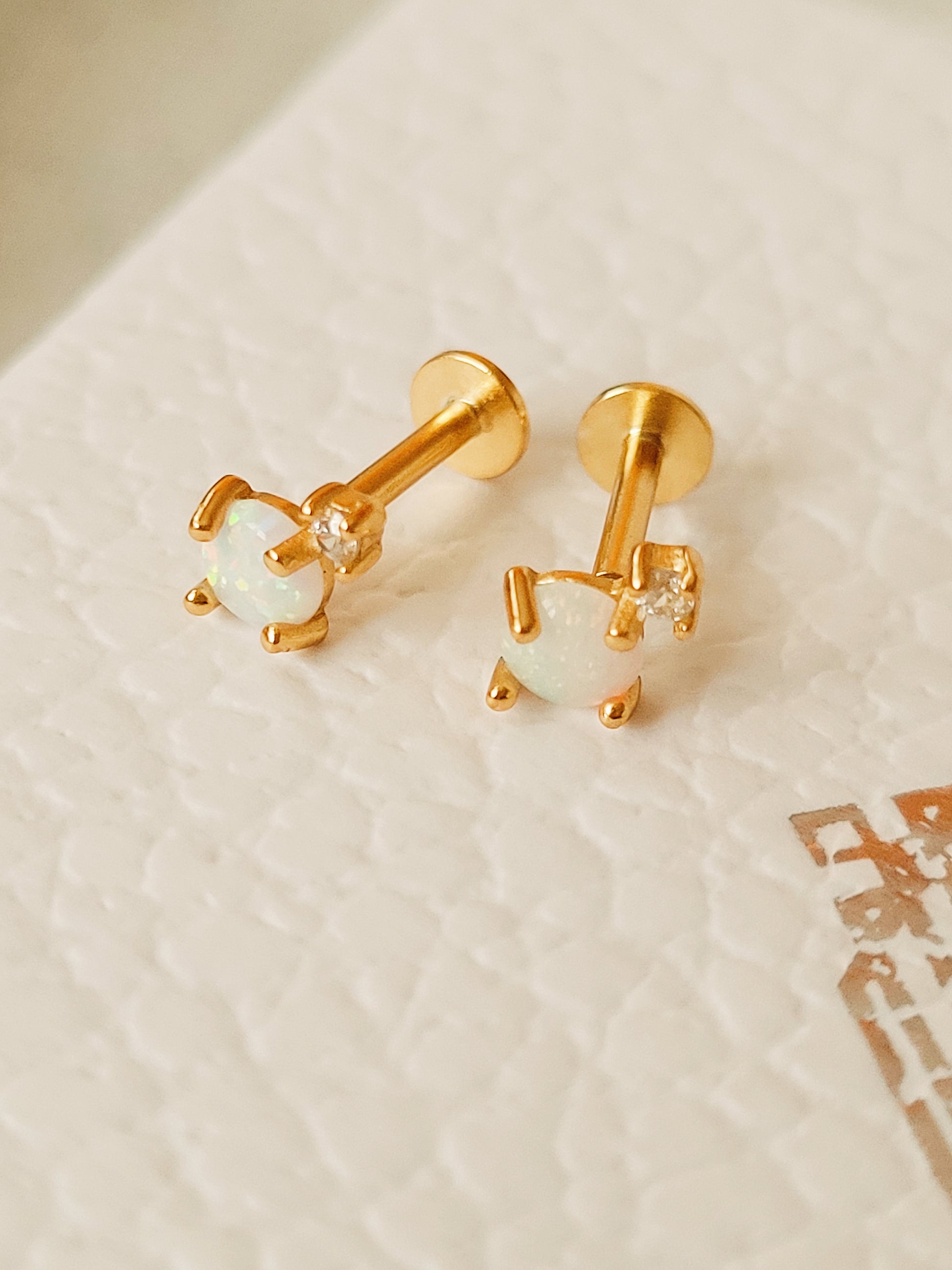 Mini round opal stud earrings in 18K gold vermeil on a white background, emphasizing the minimalist design.