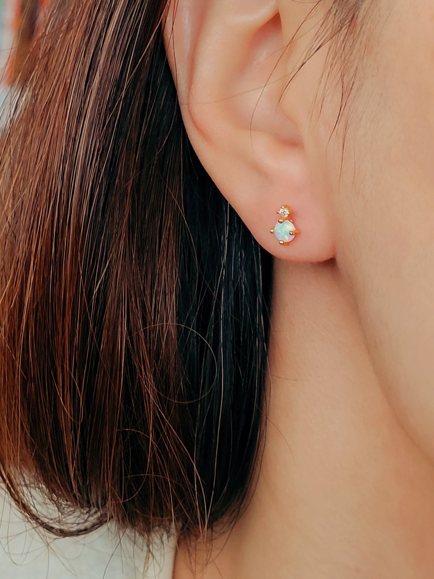 Side view of mini opal earrings, highlighting the intricate craftsmanship and gold vermeil finish. Perfect to stack with other studs.