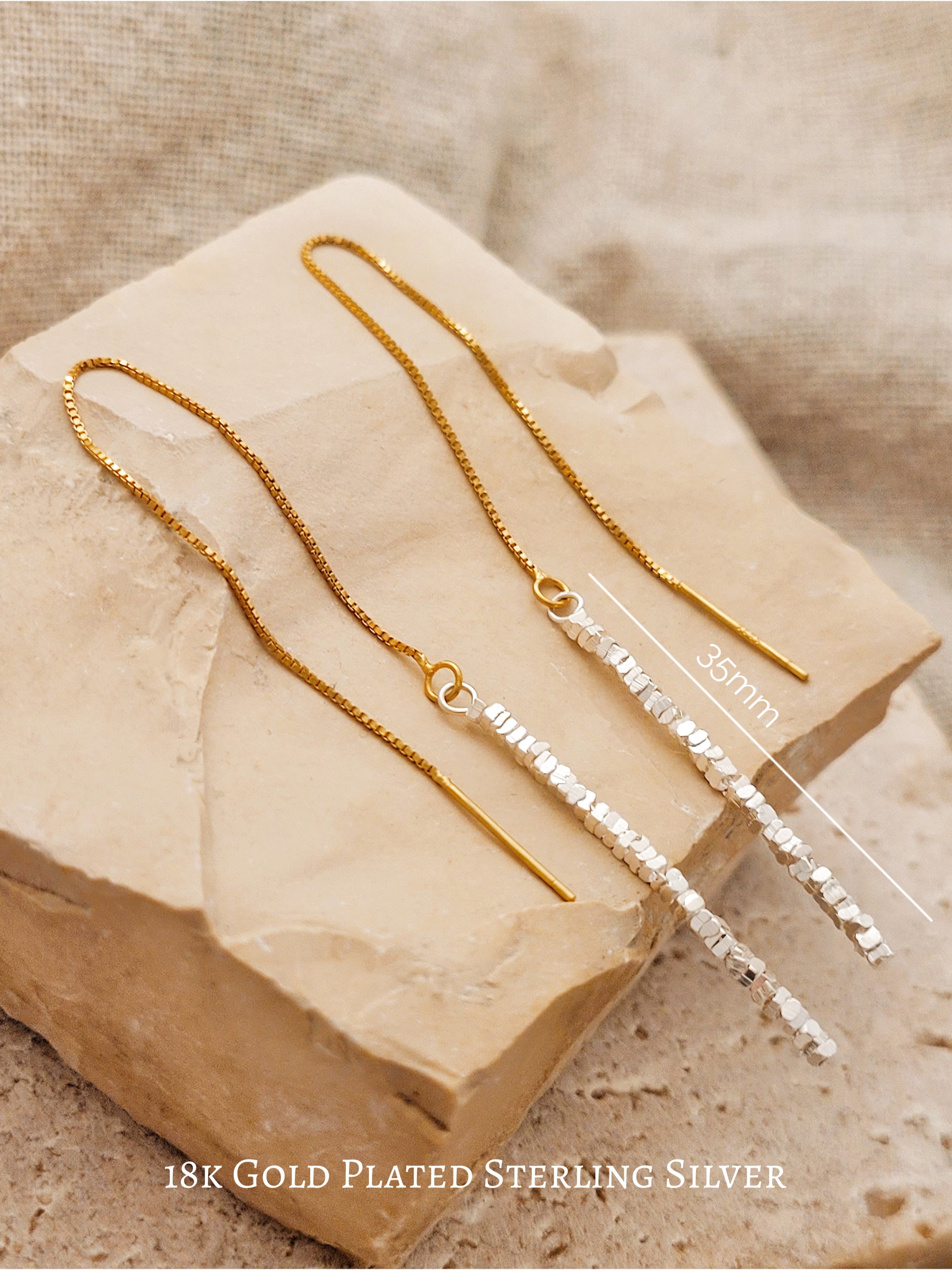 Detailed close-up of shimmering sterling silver nuggets with a raw organic texture on a gold-plated ear wire.