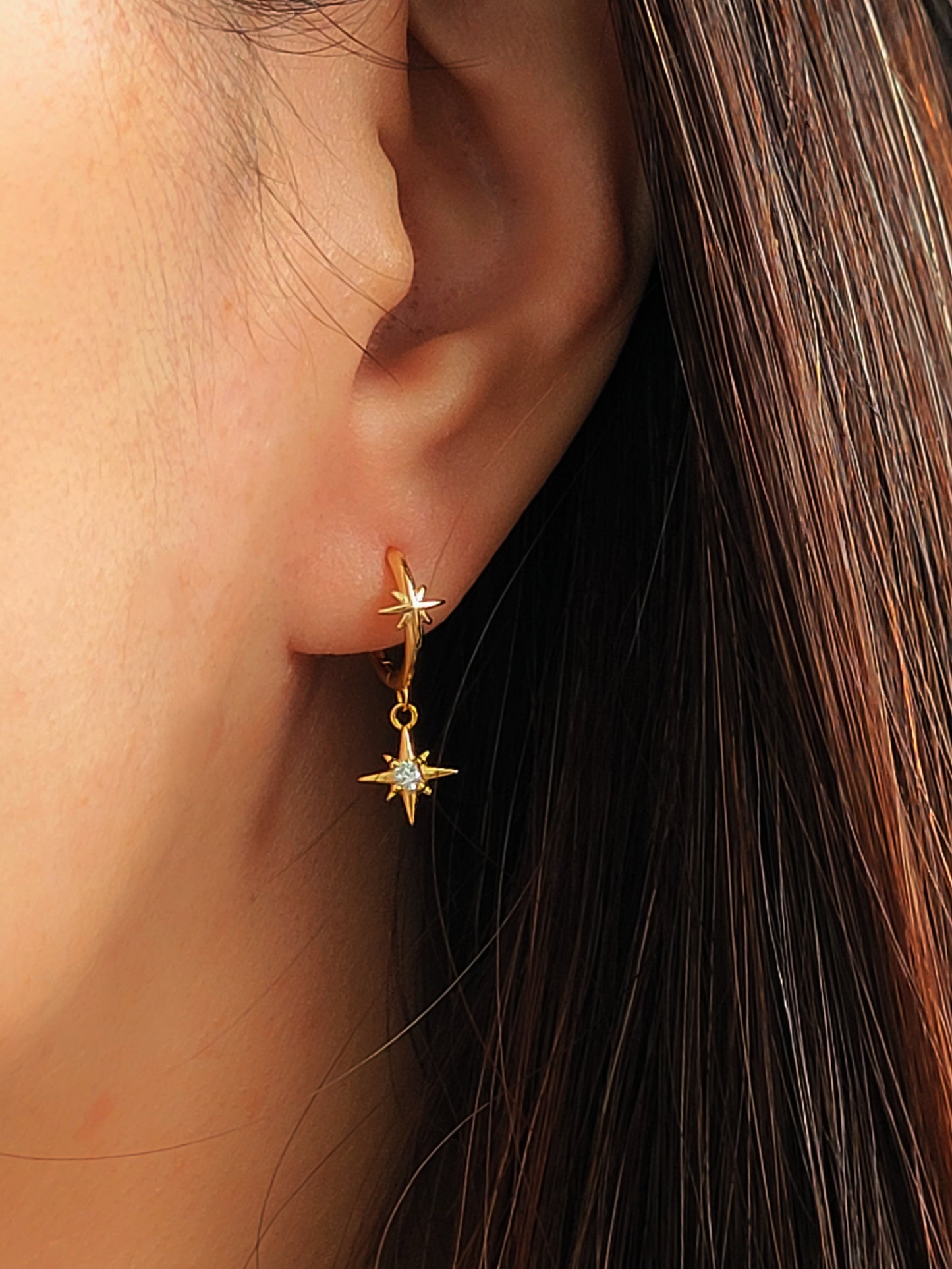 A woman wearing gold plated sterling silver star earrings, jewellery gift for her