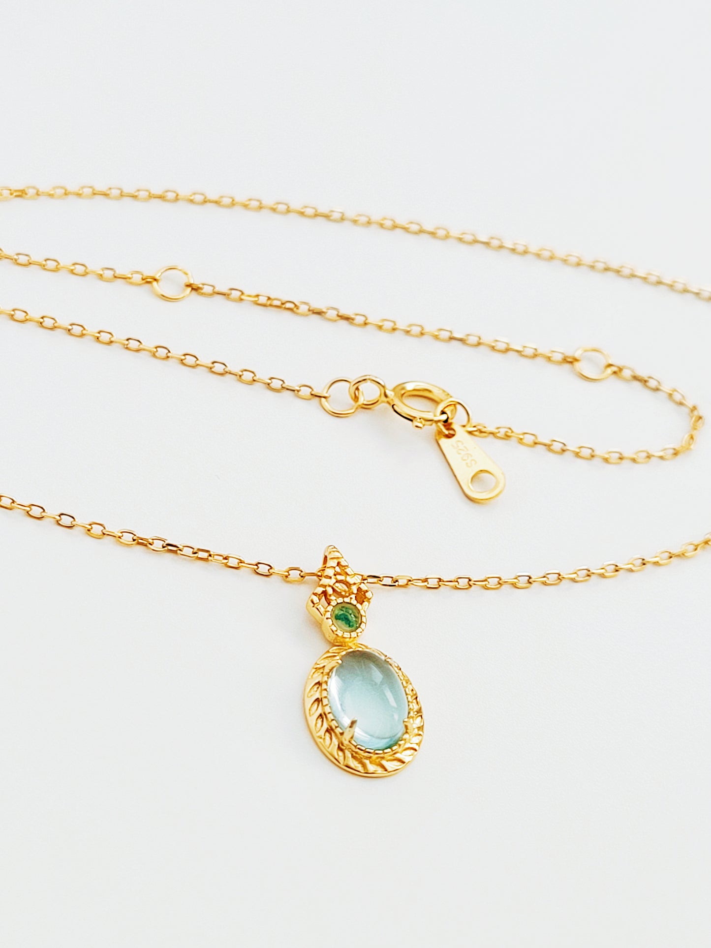 Vintage inspired adjustable gold-plated chain necklace featuring blue topaz and green gemstone accents.  Perfect anniversary gift for her.