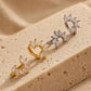 Set of dainty floral huggie hoop earrings crafted in gold plated sterling silver featuring flower shaped arrangement of a pile of marquise cubic zirconia stone, elegant and edgy jewellery