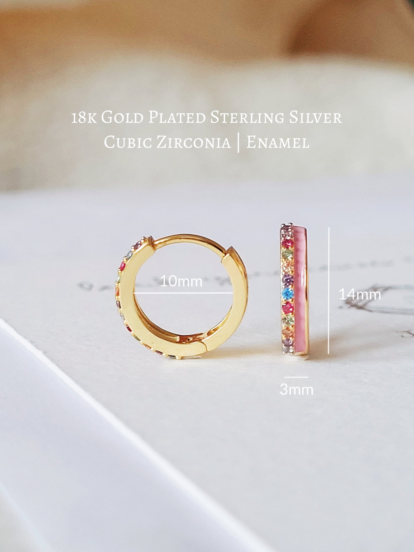 Funky pink enamel hoop earrings with rainbow crystal styled for a boho chic look. Crafted in gold plated sterling silver.