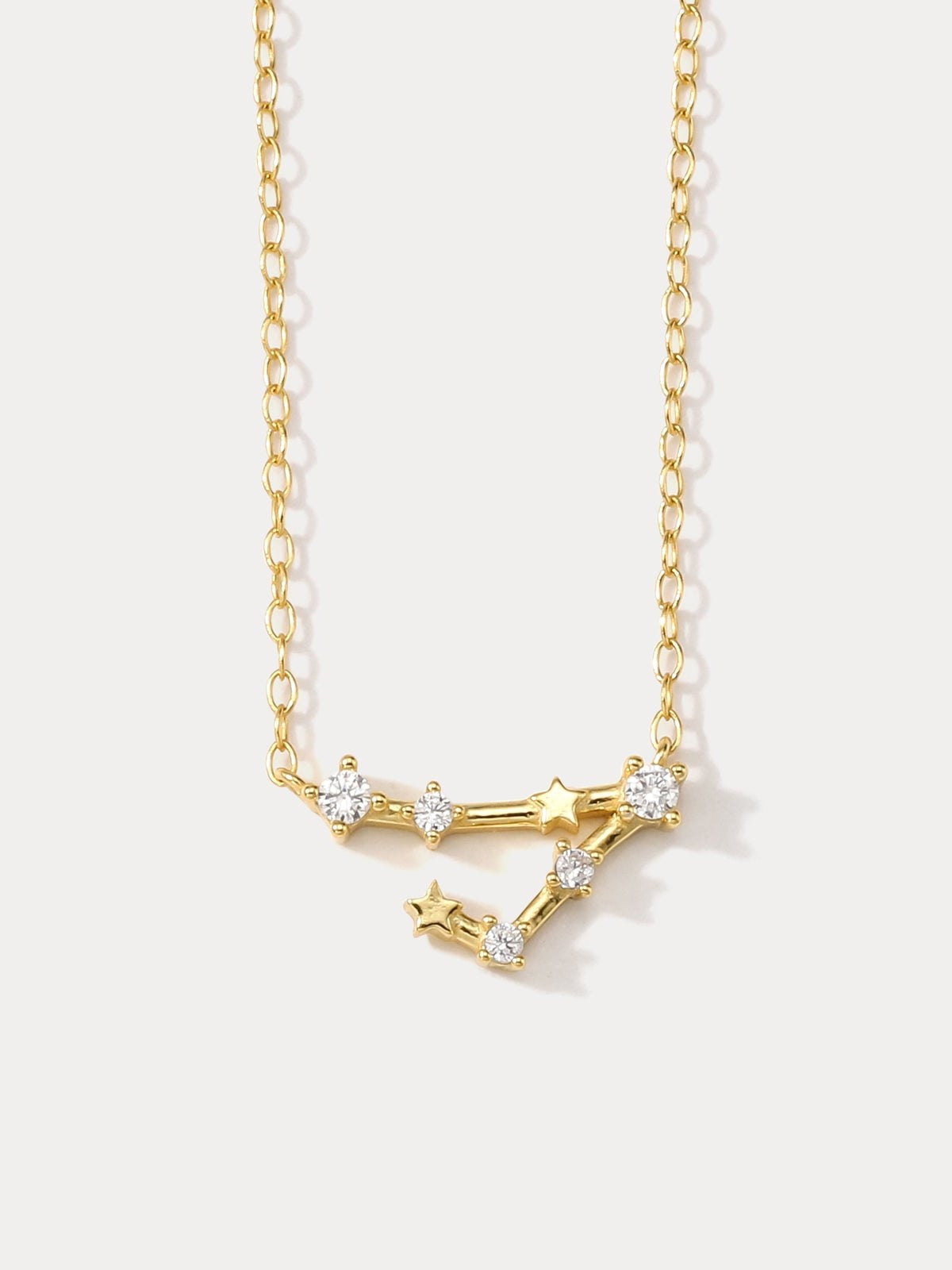 A gold-plated necklace featuring a delicate design with sparkling zircons, representing the Pisces zodiac sign.