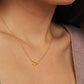 Close-up of a woman wearing an Pisces necklace showcasing the luxury aesthetic and pendant scale. Crafted in gold vermeil, a perfect jewellery gift for her.