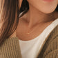 Close-up of a woman wearing an Pisces necklace showcasing the luxury aesthetic and pendant scale. Crafted in gold vermeil, a perfect jewellery gift for her.