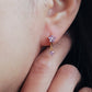 Romantic Valentine’s Day gift idea: purple flower earrings with cubic zirconia charm on an ear, crafted in 18k gold plated sterling silver and cubic zirconia.